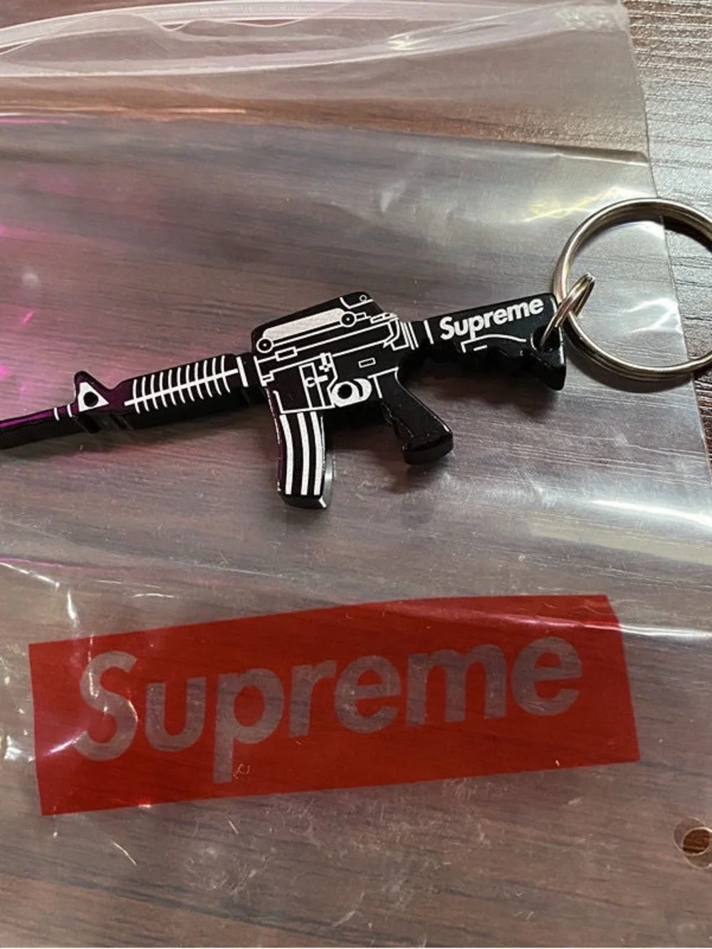 Supreme Black Rifle-Shaped Keychain Bottle Opener with Red Logo Sticker